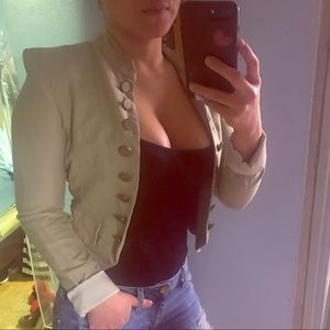 This beige blazer is a size x-small from Guess.